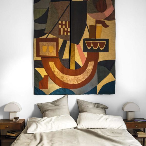 A obra de arte faz, sozinha, a decoração do quarto. A tapeçaria francesa dos anos 1950 é da Josephine House, assim como as luminárias anos 1970, de Hervé Guzzini
